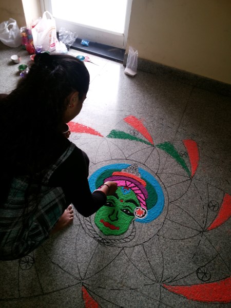 Oneindia Onam 2013 Rangoli -adding colors to face