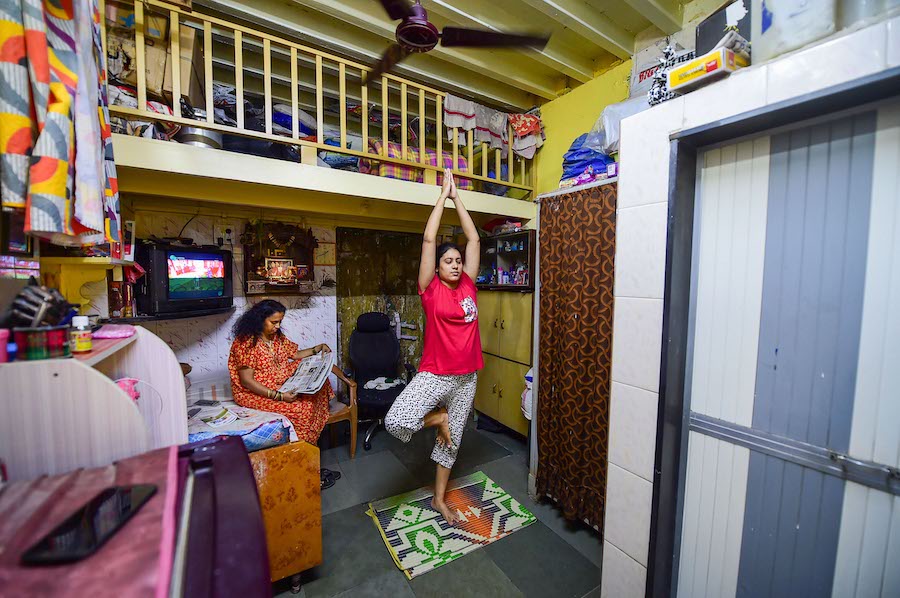 Practising Yoga at her chawl during the nationwide lockdown imposed in a bid to contain the spread of coronavirus pandemic, at Parel in Mumbai. With lockdown being implemented by most countries in the global fight against COVID-19, many professionals as well as non-professionals have adopted various novel ways to cope with this once in a lifetime kind of situation. (PTI Photo/Shashank Parade)