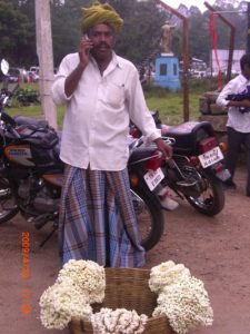 Flower man in Kodaikanal using a mobile
