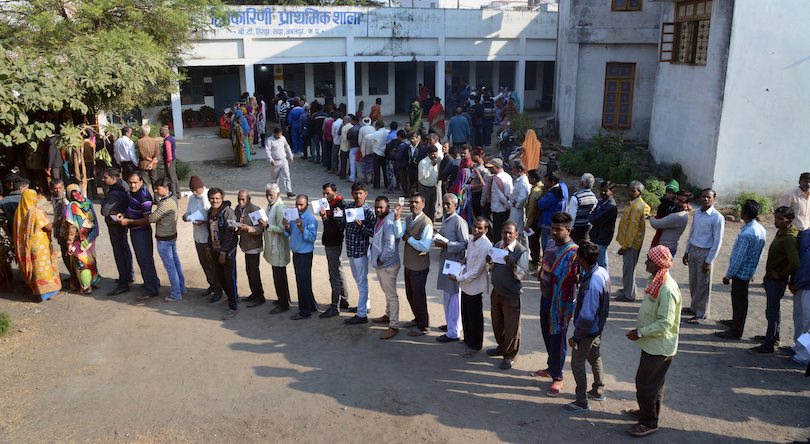 People wait with their identity cards to cast their votes for the Assembly elections, in Jabalpur, Madhya Pradesh, Wednesday, Nov 28, 2018.