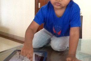 A 2 year old using iPad comfortably