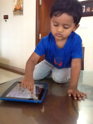 A 2 year old using iPad comfortably