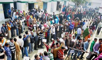 Voters stand in queue to cast their vote during the second phase of UP assembly polls in Moradabad. Source PTI
